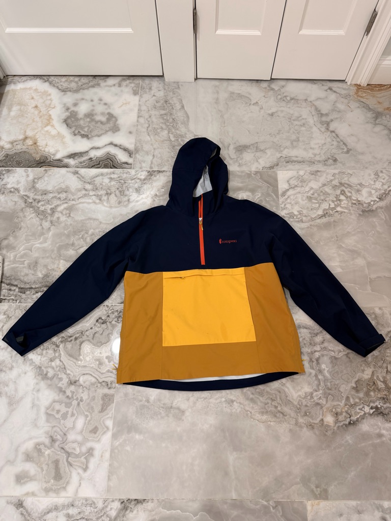 Cotopaxi Navy Jacket With Bright Orange Accents